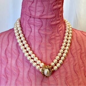 Vintage  double-strand faux pearl necklace with a decorative front clasp.